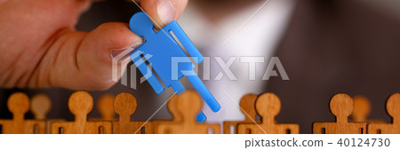 Man arm in suit take little plastic toy figure Man arm in suit take little plastic toy figure 40124730