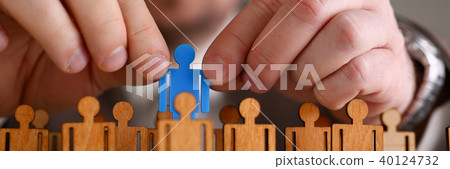 Man arm in suit take little plastic toy figure Man arm in suit take little plastic toy figure 40124732