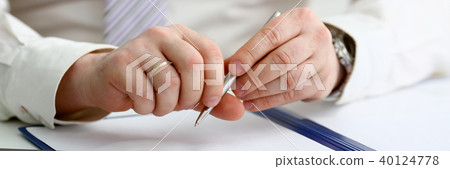Male arm in suit and tie hold silver pen 40124778