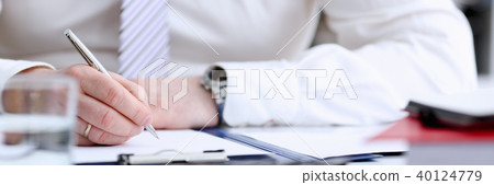 Male arm in suit and tie hold silver pen Male arm in suit and tie hold silver pen 40124779