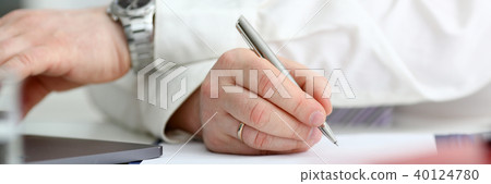 Male arm in suit and tie hold silver pen 40124780