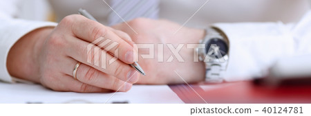 Male arm in suit and tie hold silver pen 40124781