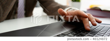 Male arms in suit typing on silver keyboard 40124872