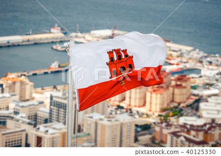 close up of Gibraltar flag waving against blue sky close up of Gibraltar flag waving against blue sky 40125330