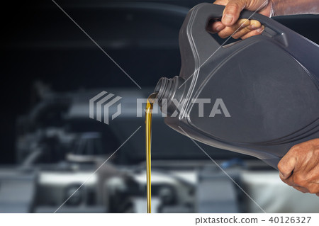 Pouring oil lubricant motor car from bottle Pouring oil lubricant motor car from bottle 40126327