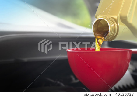 Pouring oil lubricant motor car from bottle Pouring oil lubricant motor car from bottle 40126328