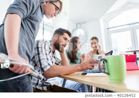Self-employed young man analyzing a difficult task while working 40126452