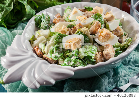 Caesar salad with cheese, eggs and croutons 40126898