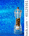 Pepper grinds closeup  on blue background 40129361