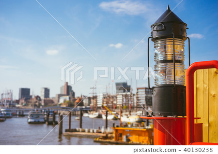 Red light lantern in HafenCity. ght. Port piers with ships and yacht at anchor in background 40130238