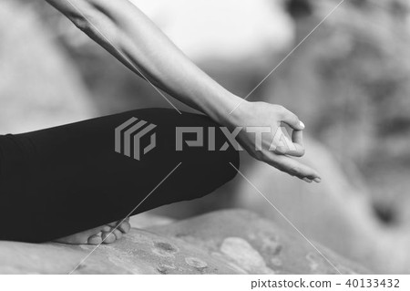 Young woman practicing yoga outdoors 40133432