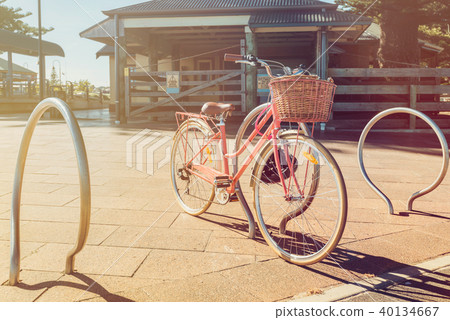 Pink vintage bicycle with basket on steering wheel Pink vintage bicycle with basket on steering wheel 40134667
