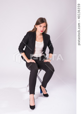 beautiful sexual businesswoman sitting on chair on white background. beautiful sexual businesswoman sitting on chair on white background. 40136359