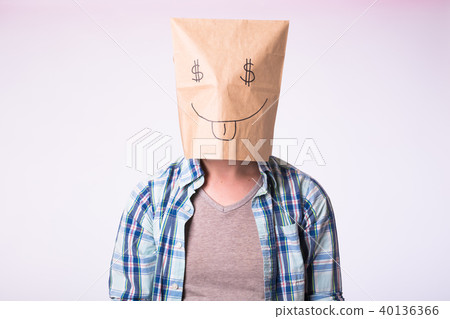 Man with cardboard box on his head with picture of dollar symbol instead of eyes. Man with cardboard box on his head with picture of dollar symbol instead of eyes. 40136366