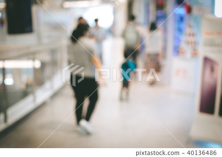 Blurred image people and bookshelves in library Blurred image people and bookshelves in library 40136486