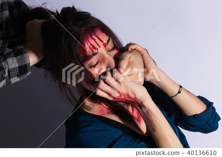 Sexual abuse with a man attacking to a scared woman in a dark place. Sexual abuse with a man attacking to a scared woman in a dark place. 40136610