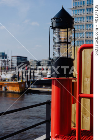 Red light lantern in HafenCity. ght. Port piers with ships and yacht at anchor in background 40137138