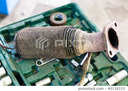 old burnt corrugation muffler on set of tools 40138153