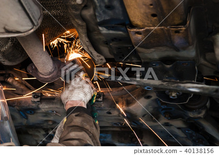 mechanic cleans silencer pipe by angle grinder mechanic cleans silencer pipe by angle grinder 40138156