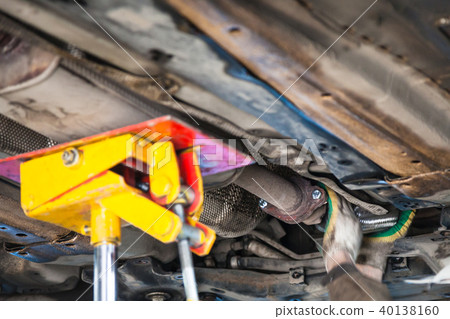 mechanic fixes silencer pipe on car mechanic fixes silencer pipe on car 40138160