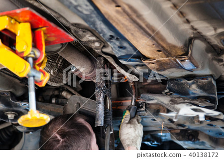 repairer welds silencer on car by argon welding repairer welds silencer on car by argon welding 40138172