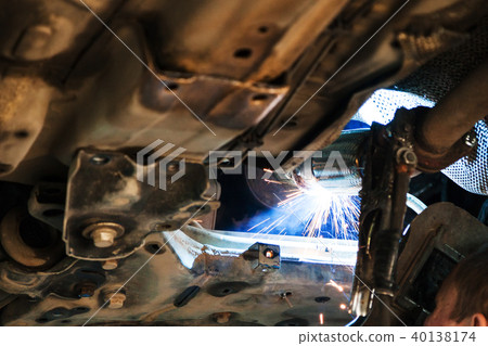 welder welds silencer on car by argon welding welder welds silencer on car by argon welding 40138174