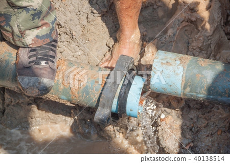 worker male repair plumbing broken pipe in hole worker male repair plumbing broken pipe in hole 40138514