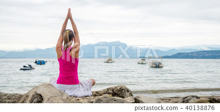 Woman meditating at the lake 40138876