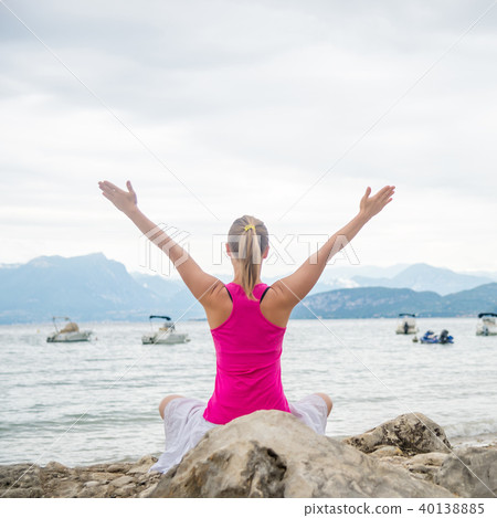 Woman meditating at the lake 40138885