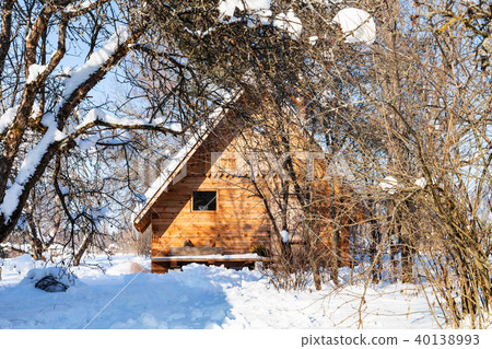 wooden cottage in snow-covered garden in winter wooden cottage in snow-covered garden in winter 40138993