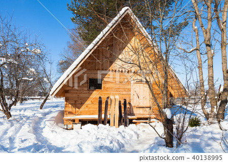 view of little timber cottage and wide skis 40138995