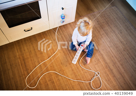 Toddler boy in dangerous situation at home. Child safety concept. 40139049