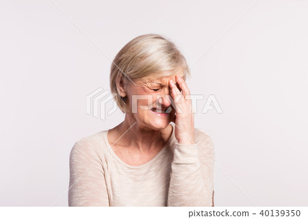 Studio portrait of a senior woman in pain. 40139350