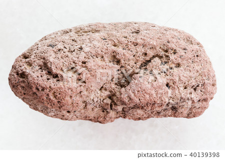 pebble of red pumice stone on white marble 40139398
