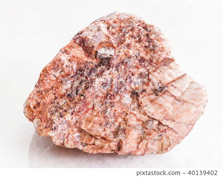 piece of pink Granite stone on white marble 40139402