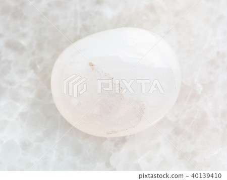 polished milky quartz gemstone on white marble polished milky quartz gemstone on white marble 40139410