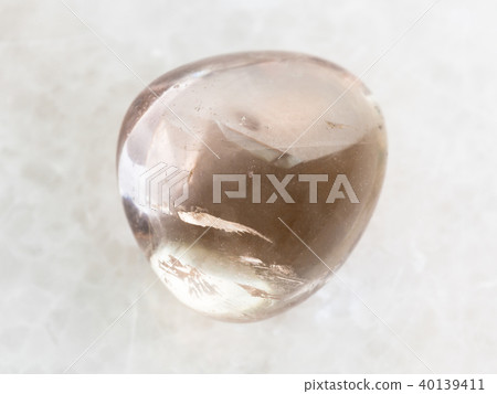 tumbled smoky quartz gem stone on white marble tumbled smoky quartz gem stone on white marble 40139411