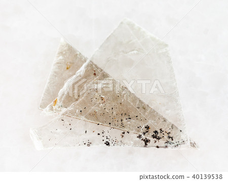 raw muscovite mica lamina on white marble 40139538