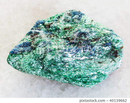 raw Fuchsite (chrome mica) stone on white marble raw Fuchsite (chrome mica) stone on white marble 40139662