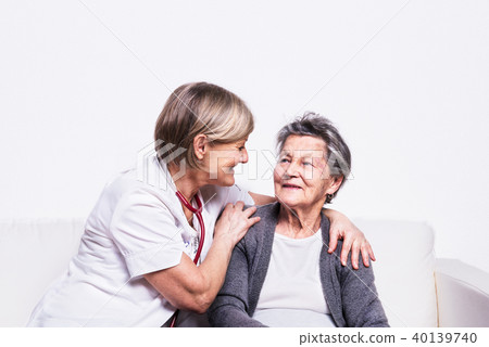 Studio portrait of a senior nurse and an elderly woman. Studio portrait of a senior nurse and an elderly woman. 40139740