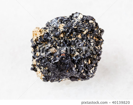 raw Perovskite stone on white marble raw Perovskite stone on white marble 40139820