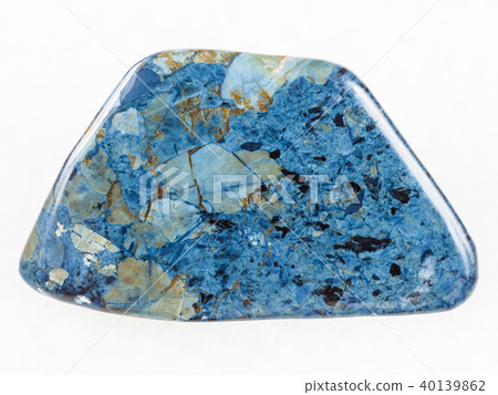 tumbled rhodusite gemstone on white marble 40139862