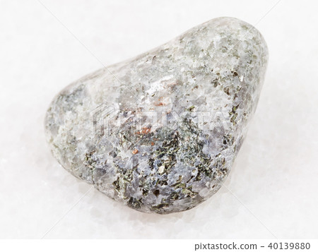 tumbled calcite stone with chondrodite on white tumbled calcite stone with chondrodite on white 40139880
