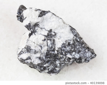 Bismuthinite vein in rough quartz stone on white 40139898