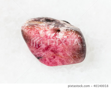 tumbled pink rhodonite gem stone on white 40140018