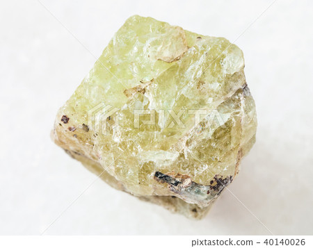 raw crystal of Saamite (fluorapatite) on white raw crystal of Saamite (fluorapatite) on white 40140026