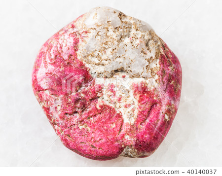 tumbled Thulite gemstone on white 40140037