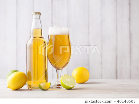 Bottle and glass of lager beer with lemon and lime 40140505