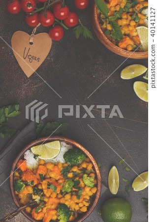 Vegan Sweet Potato Chickpea curry in wooden bowl Vegan Sweet Potato Chickpea curry in wooden bowl 40141127