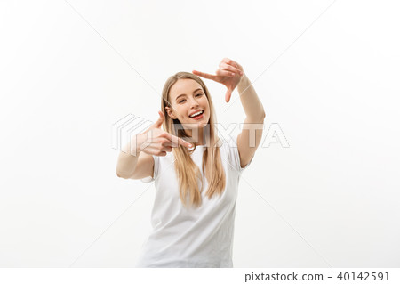 Portrait of young beautiful caucasian woman with cheerfuly smiling making a camera frame with 40142591